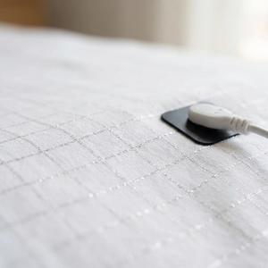 Macro of the silver conductive grid weave and snap plate
