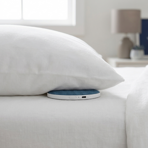 DriftDisc sitting flat under a pillow with almost no bulge