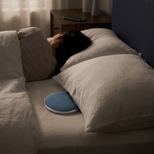 Night bedroom, one person asleep while DriftDisc plays under the other pillow